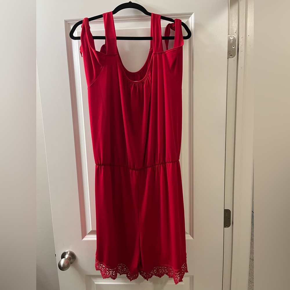 Red short jumper with cold shoulder feature.